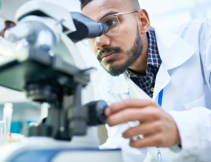 A photo of a scientist looking through a microscope